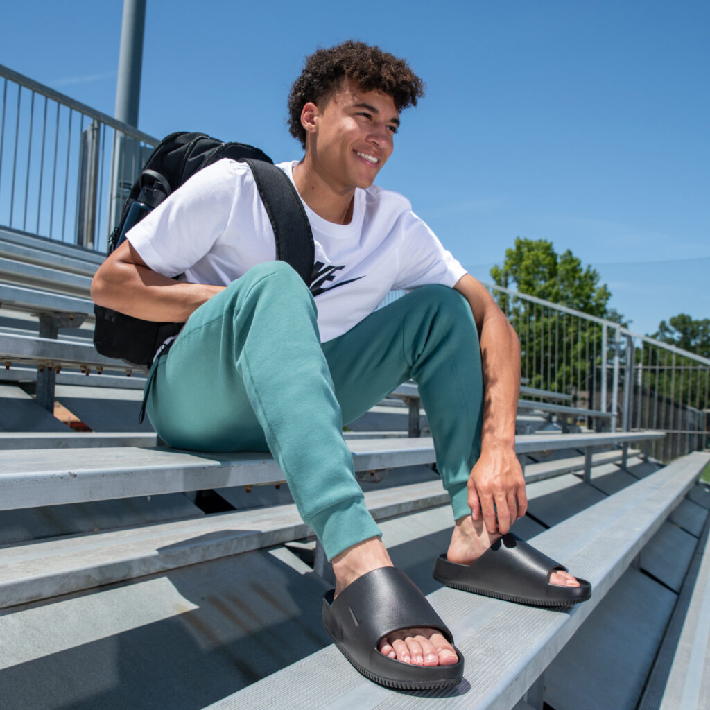 Boy wearing sport slides.